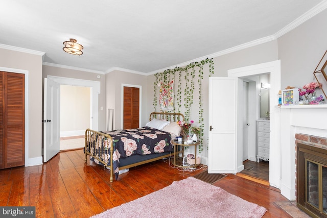 644 Early Dr, Broadway, VA 22815 - bedroom featuring crown molding, wood-type flooring, a fireplace, baseboards, and connected bathroom