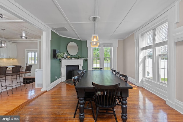 644 Early Dr, Broadway, VA 22815 - dining area featuring wood-type flooring, a fireplace with flush hearth, ornamental molding, and baseboards