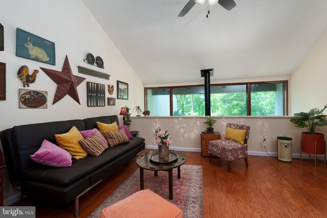 living room with wood finished floors, plenty of natural light, ceiling fan, lofted ceiling, and baseboards