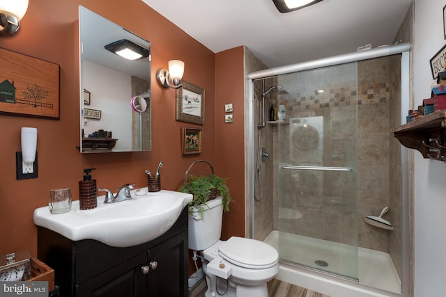 full bath featuring a shower stall, toilet, and vanity