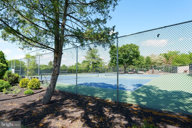 view of tennis court with fence
