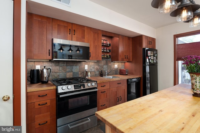 kitchen with black appliances, wooden counters, backsplash, a sink, and open shelves