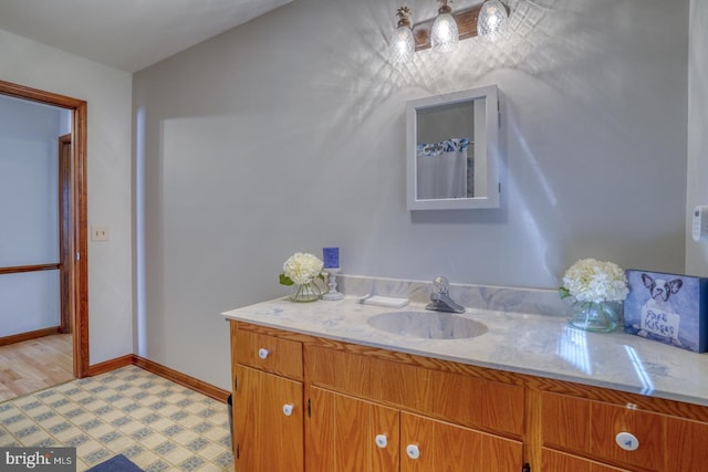 bathroom with vanity and baseboards