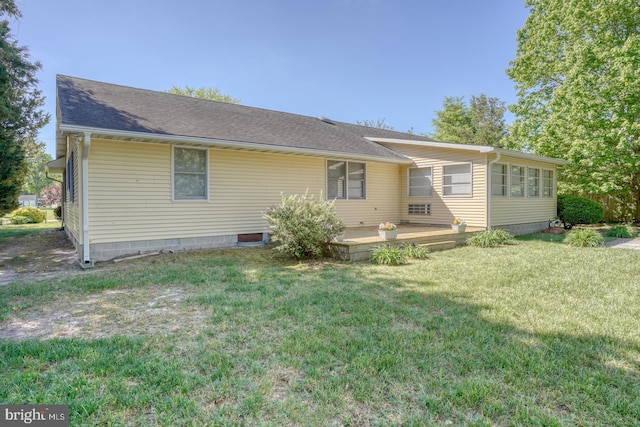 back of property with a yard and a patio