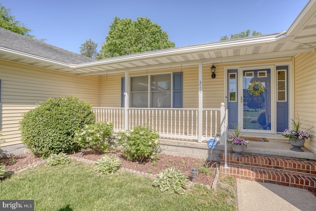 view of exterior entry with covered porch