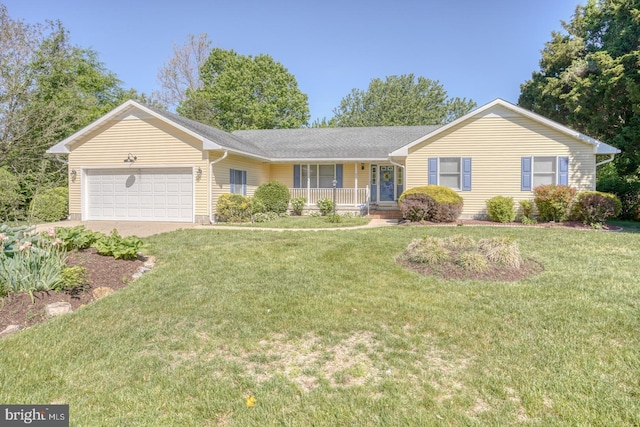 ranch-style house with covered porch, a garage, and a front yard