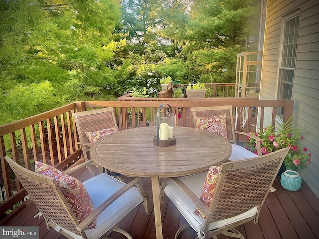 wooden terrace featuring outdoor dining area