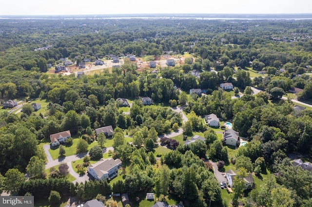 aerial view of residential area featuring a forest