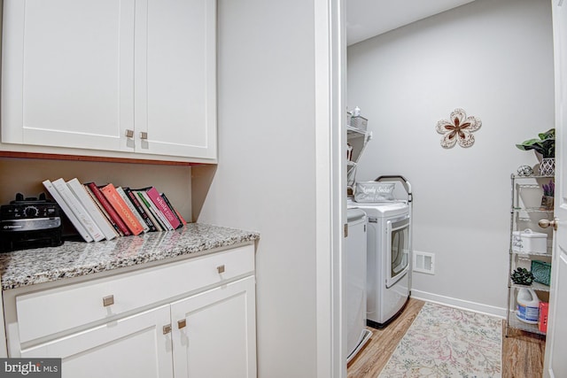 1143 Kayla Ln, Townsend, DE 19734 - clothes washing area featuring light wood-type flooring, washer and clothes dryer, and baseboards