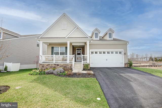 1143 Kayla Ln, Townsend, DE 19734 - view of front of house with a porch, an attached garage, asphalt driveway, and a front lawn