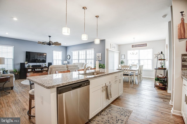 1143 Kayla Ln, Townsend, DE 19734 - kitchen featuring stainless steel dishwasher, a sink, white cabinetry, a ceiling fan, and wood finished floors