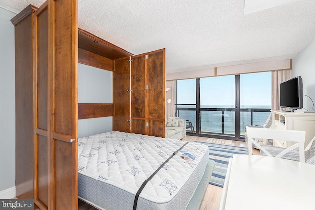 10900 Coastal Hwy Unit 805, Ocean City, MD 21842 - bedroom featuring a textured ceiling and wood finished floors