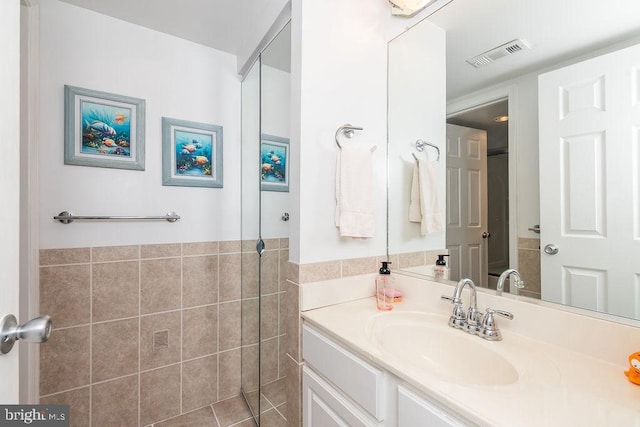 10900 Coastal Hwy Unit 805, Ocean City, MD 21842 - bathroom with tile walls, vanity, and wainscoting