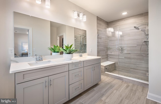 ensuite bathroom with a shower stall and double vanity