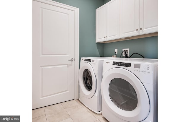 laundry room featuring cabinet space, independent washer and dryer, and light tile patterned floors