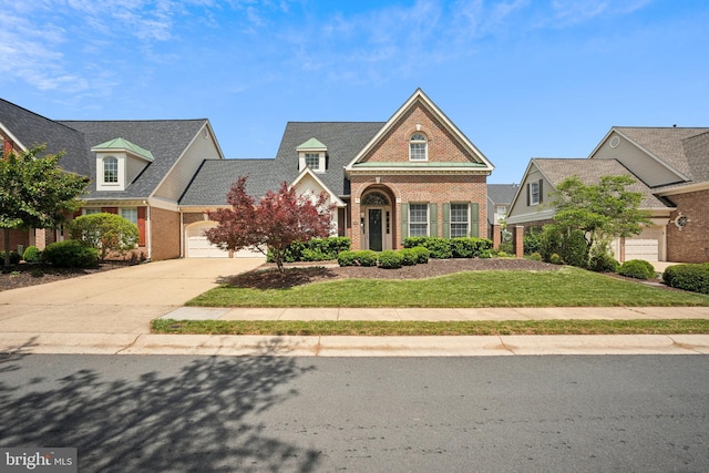 43692 Bermuda Dunes Ter, Leesburg, VA 20176 - view of front facade featuring brick siding, driveway, an attached garage, and a front yard