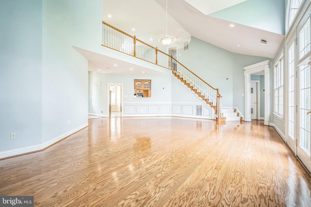43692 Bermuda Dunes Ter, Leesburg, VA 20176 - unfurnished living room featuring a high ceiling, wood finished floors, stairs, baseboards, and recessed lighting