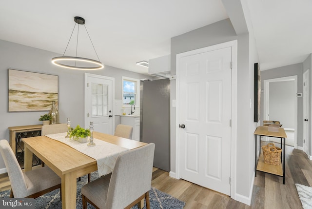 3531 Milford Mill Rd, Baltimore, MD 21244 - dining room with light wood-type flooring and baseboards
