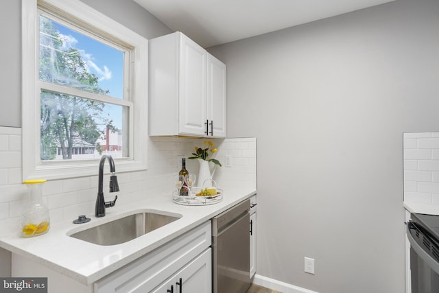 3531 Milford Mill Rd, Baltimore, MD 21244 - kitchen with dishwasher, a sink, backsplash, white cabinetry, and electric range oven