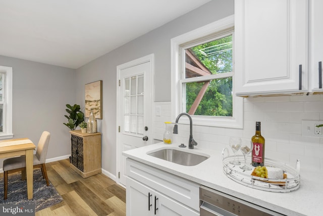 3531 Milford Mill Rd, Baltimore, MD 21244 - kitchen with a sink, wood finished floors, tasteful backsplash, white cabinetry, and dishwasher