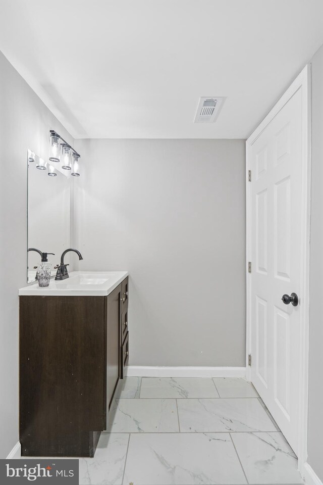 3531 Milford Mill Rd, Baltimore, MD 21244 - bathroom with marble finish flooring, vanity, and baseboards