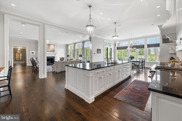 101 Greenspring Rd, Wilmington, DE 19807 - kitchen with a chandelier, a high end fireplace, ornamental molding, recessed lighting, and white cabinetry