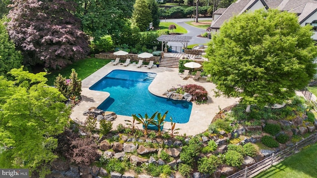 101 Greenspring Rd, Wilmington, DE 19807 - outdoor pool with a patio, stairs, and view of scattered trees