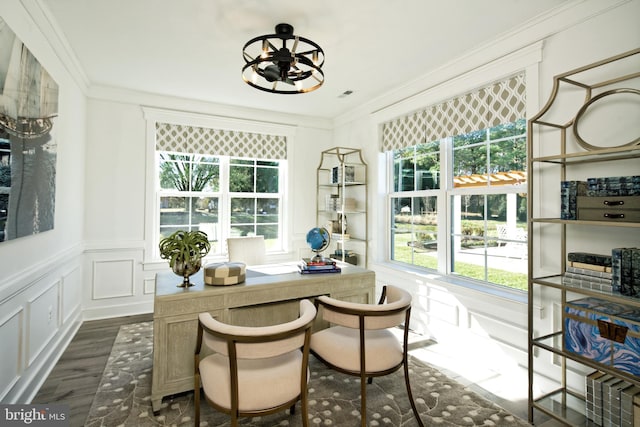 office area featuring dark wood finished floors, crown molding, a chandelier, a decorative wall, and wainscoting