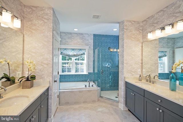 full bath featuring plenty of natural light, tile patterned flooring, a stall shower, a bath, and recessed lighting