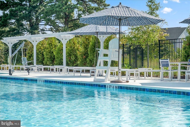 community pool featuring fence and a patio