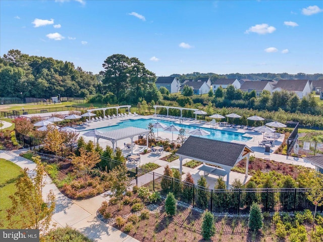community pool featuring a gazebo and fence