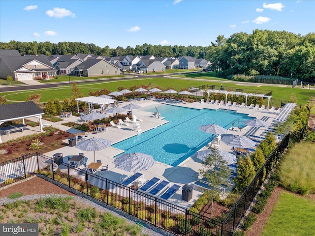 community pool with a residential view and fence