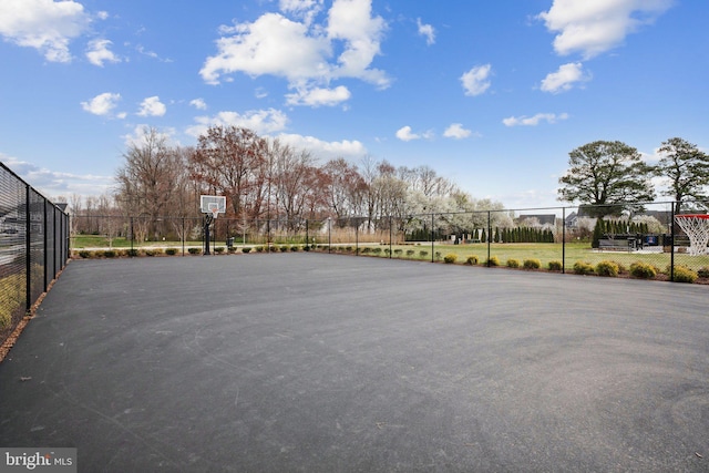 view of basketball court with community basketball court and fence