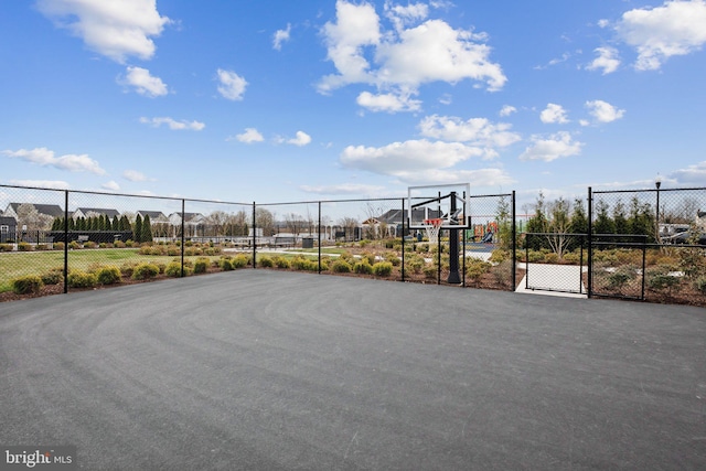 view of basketball court with fence and community basketball court