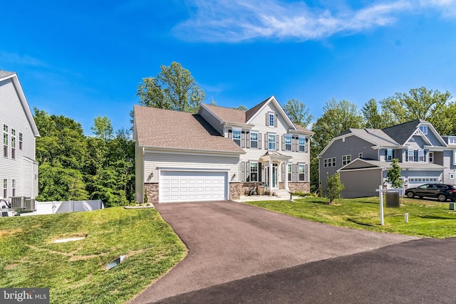 view of front of home featuring stone siding, driveway, a garage, and central air condition unit