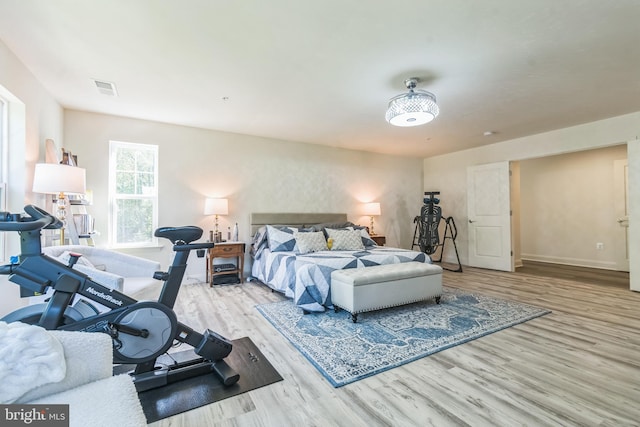 bedroom featuring wood finished floors and baseboards
