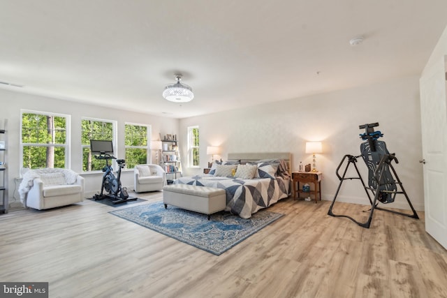 bedroom with wood finished floors and baseboards