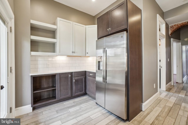 915 Westminster St NW, Washington, DC 20001 - kitchen featuring open shelves, stainless steel fridge with ice dispenser, dark brown cabinets, light wood-style floors, and light countertops