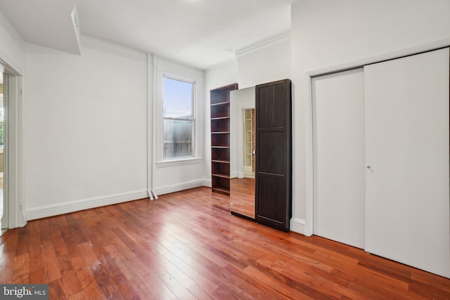 915 Westminster St NW, Washington, DC 20001 - unfurnished bedroom featuring crown molding, hardwood / wood-style flooring, a closet, and baseboards