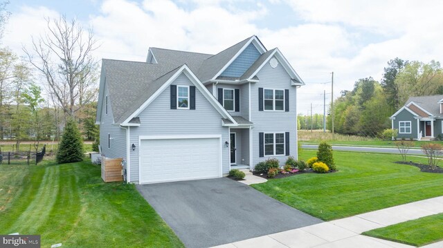 22378 Mahogany Rd, Milton, DE 19968 - traditional-style house featuring asphalt driveway, a front lawn, and an attached garage
