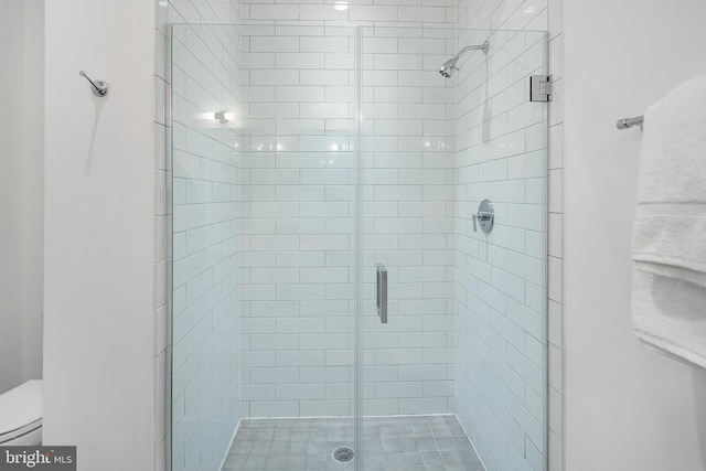 full bathroom with a stall shower and toilet