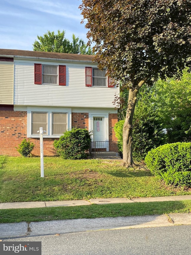 341 Chimney Oak Dr, Joppa, MD 21085 - colonial house with brick siding and a front yard