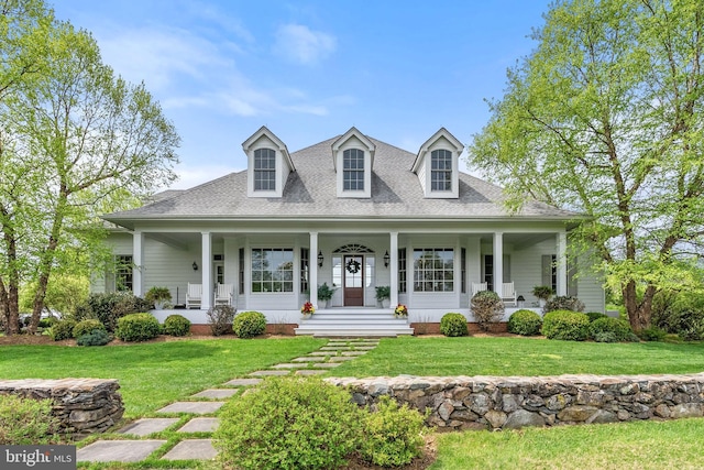view of front of house featuring covered porch, a front yard, and roof with shingles
