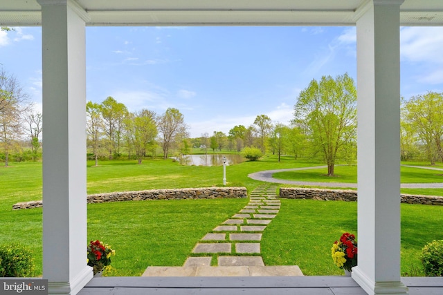 view of grassy yard with a water view