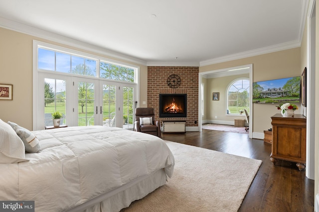 bedroom with access to outside, ornamental molding, a fireplace, dark wood-style flooring, and baseboards
