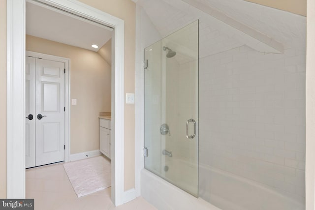 full bathroom featuring shower / bath combination with glass door, tile patterned flooring, baseboards, and vanity