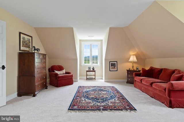 living room with light colored carpet, lofted ceiling, and baseboards