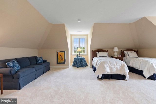 carpeted bedroom featuring lofted ceiling and baseboards
