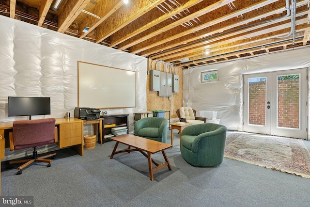 below grade area featuring carpet, an office area, french doors, and electric panel
