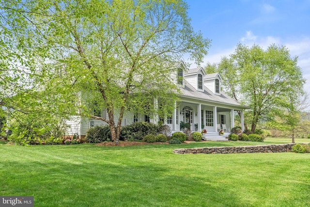 cape cod-style house with a porch and a front lawn